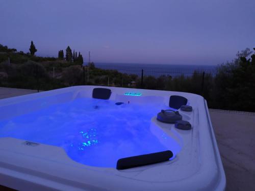 a jacuzzi tub with a view of the ocean at Casal Trinacria in Santa Teresa di Riva