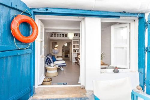 an open door to a room with an orange life preserver at Chalaris Armeni Villa in Oia