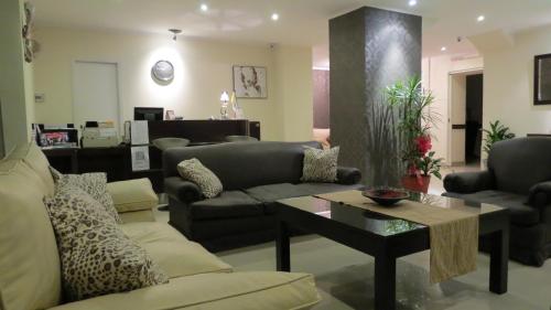 a living room with a couch and a table at Hotel Lido in Mar del Plata