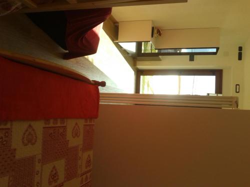 a bedroom with a bed and a window in a room at Agriturismo Botton D'Oro in Dongo