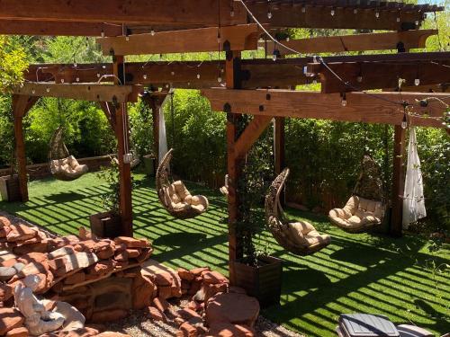 a pergola with a group of rocks in a yard at Lantern Light Inn - Romantic Getaway in Sedona