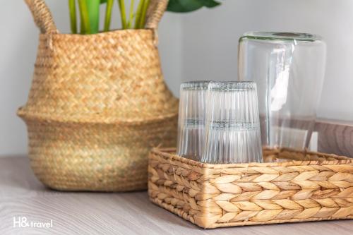 a basket with a candle and a vase on a table at Sleepier Multi-Minsu Tainan in Tainan