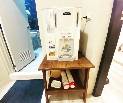 a small refrigerator on a wooden shelf in a room at 霧台山豐民宿 in Wutai