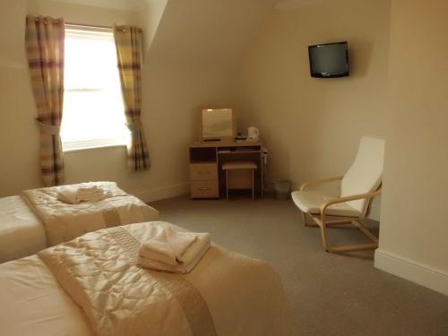 A bed or beds in a room at The Golden Lion Hotel