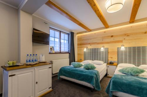 Кровать или кровати в номере Vital&Spa Resort Szarotka