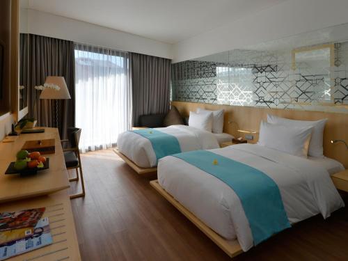A bed or beds in a room at IZE Seminyak
