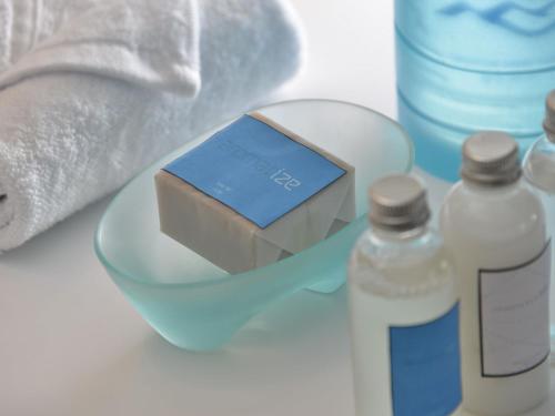 a box of soap and a bottle of water at IZE Seminyak by LifestyleRetreats in Seminyak