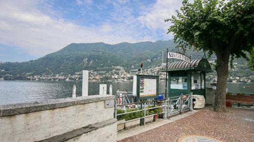 a bus stop next to a body of water at Italianway - Torno in Torno