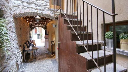 a staircase in a building with a person sitting at a table at Italianway - Torno in Torno