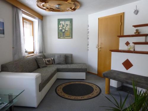 a living room with a couch and a table at Ferienwohnungen Hauser in Waidring