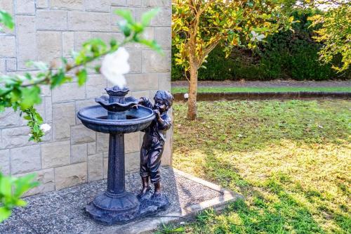 a statue of a boy drinking out of a fountain at Cal Soi in Lleida