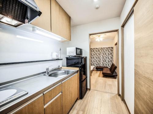 a kitchen with a sink and a microwave at Terrace Resort Chatan West in Chatan