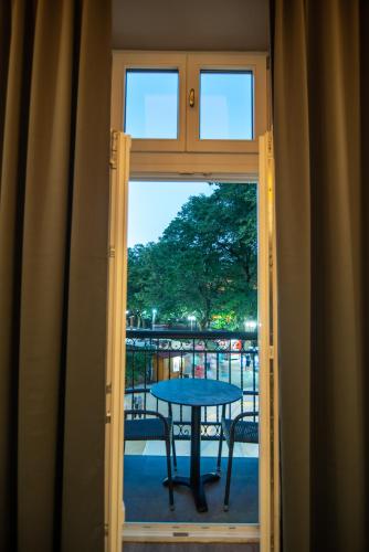 a view of a table through a glass door at Vila Emilia in Vrnjačka Banja