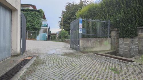 an empty street with a gate and a building at Italianway - Torno in Torno