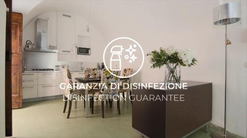 a kitchen with a table and chairs in a room at Italianway - Torno in Torno
