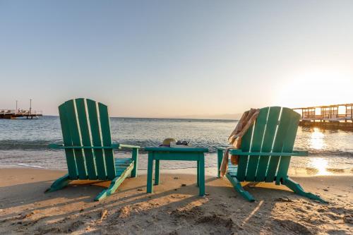 two chairs and a table on the beach at Grand Hotel Ontur Cesme in Cesme