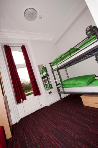 a room with two bunk beds and a window at YHA Castleton Losehill Hall in Castleton