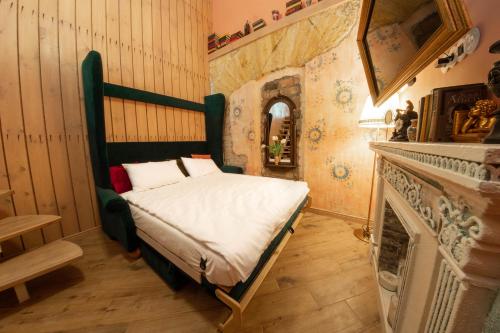 a bedroom with a bed in a room with a fireplace at Трирівневий лофт із спальнею-укриттям SELF Check-in 247 in Odesa