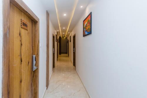 a corridor with white walls and a hallway with a hallway at Hotel Riva International Goregaon- Near NESCO in Mumbai
