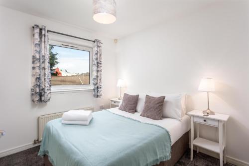 a bedroom with a bed and a window at Walker Suite No82 - Donnini Apartments in Kilmarnock