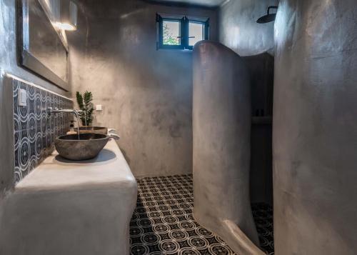 a bathroom with a sink and a potted plant at Petra Residence Mini Pool Spa in Adamas