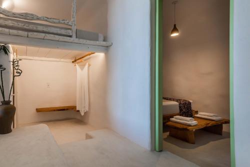 a room with a bunk bed and a bench at Petra Residence Mini Pool Spa in Adamas