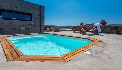 a swimming pool on a patio with a table at Petra Residence Mini Pool Spa in Adamas