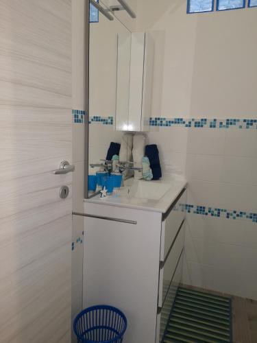 a bathroom with a sink and a mirror at Casa di Giò - Alghero in Alghero