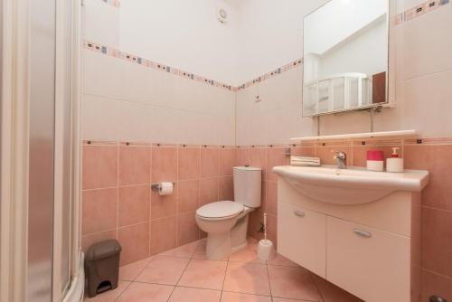 a small bathroom with a toilet and a sink at Apartment Astoria in Zaton