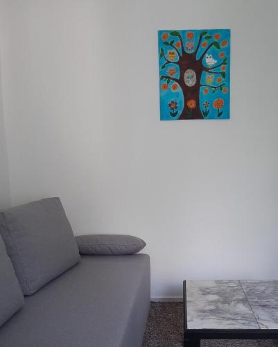 a living room with a couch and a picture on the wall at SAUNA Dom in Pezinok