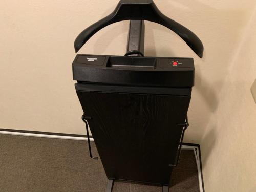 a black printer sitting on a stand next to a wall at Roppongi Plaza Hotel in Tokyo