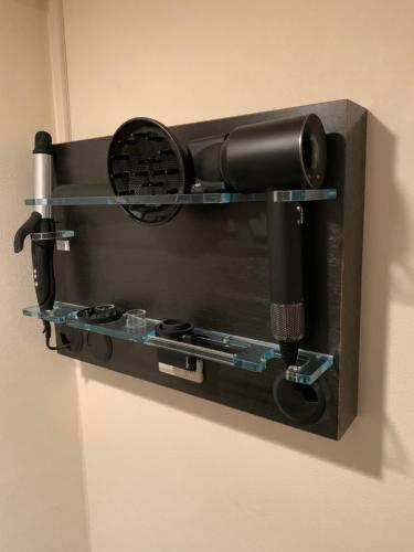 a black wall mounted camera on a wall at Roppongi Plaza Hotel in Tokyo