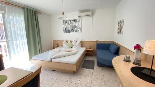a hotel room with a bed and a couch at Villa Osipovica in Medulin