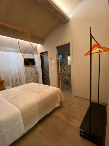 a bedroom with a bed and a pole with an object at EL TANO in Città della Pieve