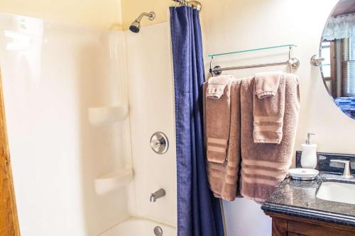 a bathroom with a shower with towels and a sink at Eagle's Nest in Big Bear Lake