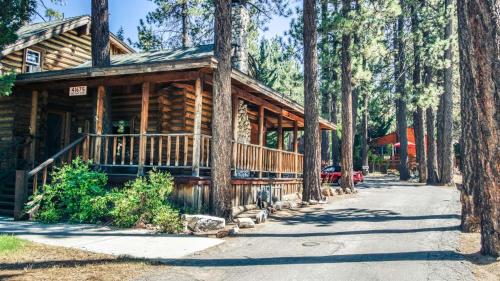 a log cabin in the woods with a driveway at Eagle's Nest in Big Bear Lake