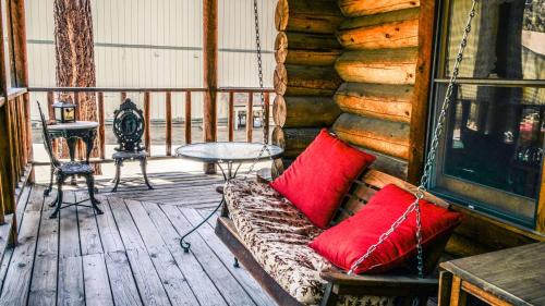 a couch sitting on a porch of a log cabin at Eagle's Nest in Big Bear Lake