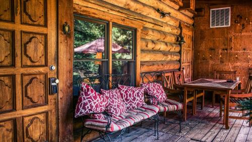 a couch on a porch of a log cabin at Eagle's Nest in Big Bear Lake