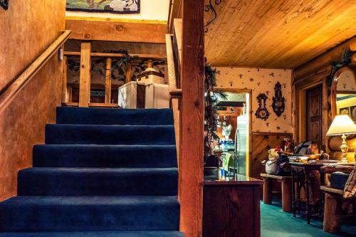 a stairway in a house with a blue carpet at Eagle's Nest in Big Bear Lake