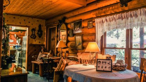 a room with a table and a window in a cabin at Eagle's Nest in Big Bear Lake