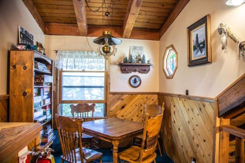 a dining room with a wooden table and chairs at Eagle's Nest in Big Bear Lake