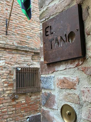 a sign on the side of a brick wall with the word el tram at EL TANO in Città della Pieve