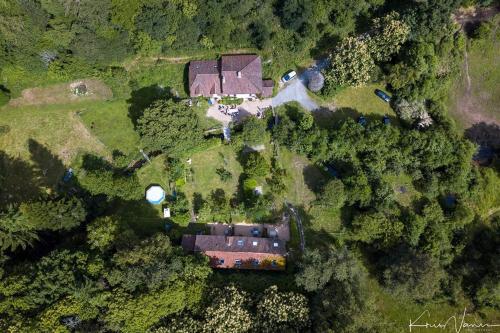 an aerial view of a house in the forest at Le Moulin de Pensol - Gites in Pensol