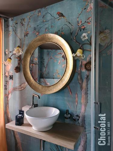 a bathroom with a sink and a mirror at The Henry Self Check-In Guesthouse in Zürich