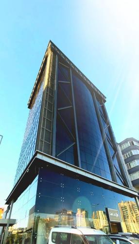 a tall building with cars parked in front of it at Le Luxe Suites Hotel & Spa in Bursa