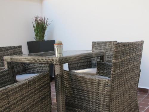 a wicker table and chairs in a room at Alhambra Hotel in London