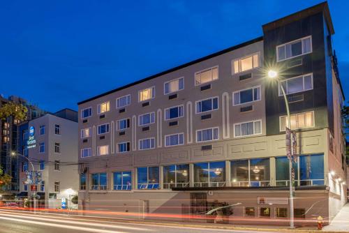 a building on the corner of a street at night at Best Western Dorchester Hotel in Nanaimo