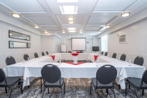a conference room with a large white table and chairs at Best Western Dorchester Hotel in Nanaimo