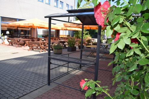 a garden area with a table and chairs at astral'Inn Leipzig Hotel & Restaurant in Leipzig
