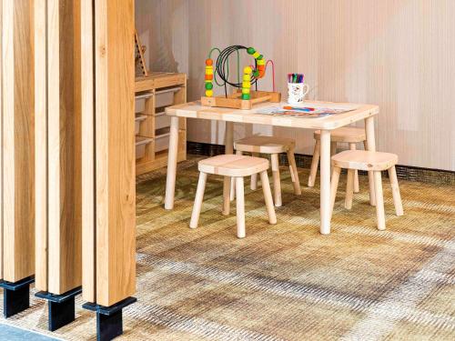a table and stools in a room with a table and chairs at ibis Styles Lublin Stare Miasto in Lublin